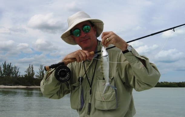 A guest holding a bonefish on the flats