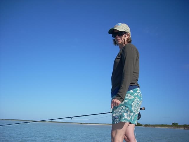 An angler at the ready on an open flat